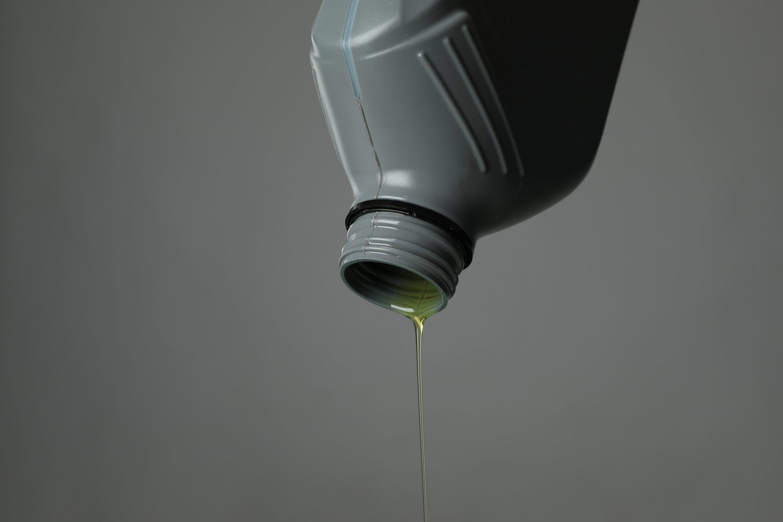 Pouring motor oil from canister on grey background 2026 01 11 10 50 22 utc scaled
